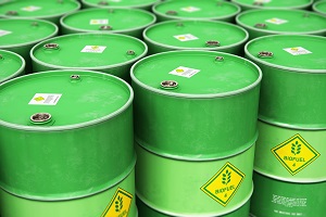 Creative abstract ecology, alternative sustainable energy and environment protection saving business concept: 3D render illustration of the group of green stacked metal biofuel drums or biodiesel barrels in the industrial storage warehouse with selective focus effect
